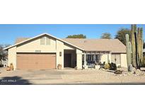 Tan one-story house with a two-car garage and desert landscaping at 1532 Leisure World --, Mesa, AZ 85206