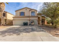 Two-story house with a double garage and a landscaped front yard at 2016 N Ensenada Ln, Casa Grande, AZ 85122