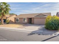 Single-story house with attached garage and desert landscaping at 2057 E Brooks St, Gilbert, AZ 85296