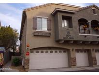 Tan two-story building with two-car garage and landscaping at 2150 W Alameda Rd # 1037, Phoenix, AZ 85085