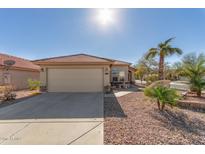 Single-story home with attached garage, desert landscaping, and driveway at 23205 W Arrow Dr, Buckeye, AZ 85326