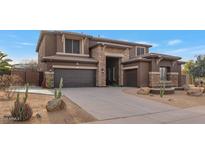 Two-story home with stone accents and a three-car garage at 2739 W Via Bona Fortuna Dr, Phoenix, AZ 85086