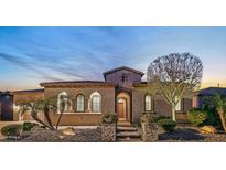 Beautiful desert home exterior at dusk with landscaped yard and two car garage at 29432 N 128Th Ln, Peoria, AZ 85383