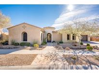 Single-story home with stucco exterior, landscaped yard, and a three-car garage at 32807 N 15Th Gln, Phoenix, AZ 85085