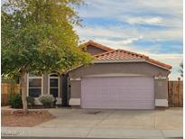 Charming single-story home featuring a tile roof, muted exterior paint and mature front-yard landscaping at 4043 E Arbor Ave, Mesa, AZ 85206