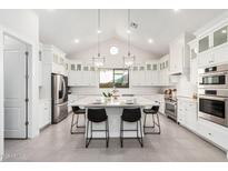 Modern kitchen with white cabinets, a large island, and stainless steel appliances at 42223 N Golden Trl, San Tan Valley, AZ 85140