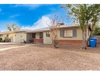 Brick Ranch home with a spacious front yard and mature trees at 4405 W Clarendon Ave, Phoenix, AZ 85031