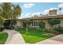 Charming single-story home featuring a lush, manicured front yard and a welcoming walkway at 4800 N 68Th N St # 228, Scottsdale, AZ 85251