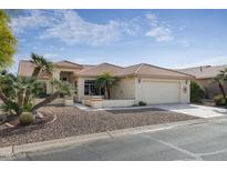 One-story house with tile roof, desert landscaping, and two-car garage at 9007 E Emerald Dr, Sun Lakes, AZ 85248