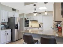 Bright kitchen features granite countertops and stainless steel appliances at 9614 W Long Hills Dr, Sun City, AZ 85351