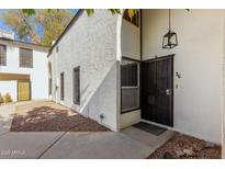 Front entrance of condo with walkway and landscaping at 1051 S Dobson Rd # 36, Mesa, AZ 85202