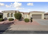 Single-story home with stucco exterior, two-car garage, and landscaped front yard at 13148 W Figueroa Dr, Sun City West, AZ 85375