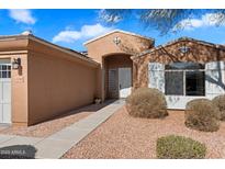 Tan house exterior with three-car garage and walkway at 15100 W Pierson St, Goodyear, AZ 85395