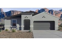 Single-story home with gray exterior, two-car garage, and landscaping at 1552 E Mason Dr, Casa Grande, AZ 85122