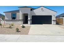 Beautiful single-story home with a two-car garage and low-maintenance desert landscaping in the front yard at 1552 E Mason Dr, Casa Grande, AZ 85122