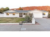 Charming single-story home featuring a manicured lawn, desert landscaping and mountain views at 1644 W Thunderbird Rd, Phoenix, AZ 85023