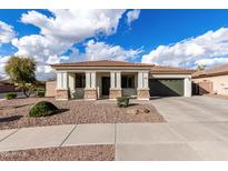 Charming single-story home with a well-maintained front yard and a two-car garage at 18906 E Cattle Dr, Queen Creek, AZ 85142