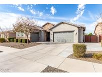 Beautiful single-Gathering home features a three-car garage, stone accents, and well-maintained landscaping at 21716 E Waverly Dr, Queen Creek, AZ 85142