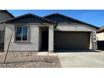 Single-story home with gray exterior and two-car garage at 25218 W Wayland Dr, Buckeye, AZ 85326