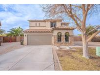 Two-story house with stone accents and a large driveway at 32504 N Cherry Creek Rd, San Tan Valley, AZ 85144