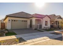 Single-story home with tan exterior, two-car garage, and landscaped front yard at 4275 E Bernice E St, Gilbert, AZ 85295