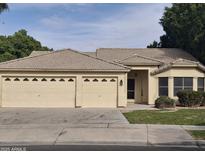 Single-story house with a three-car garage and landscaped front yard at 4841 S Vista Pl, Chandler, AZ 85248