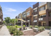 Modern community with courtyard, green space, and shaded seating areas at 6605 N 93Rd Ave # 1087, Glendale, AZ 85305