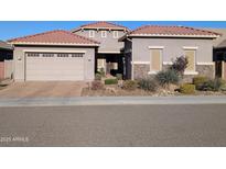 Front view of a two-story house with a three-car garage at 6616 W Side Canyon Trl, Phoenix, AZ 85083