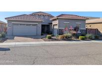 Charming single-story home with a well-maintained landscape, brick driveway, and a two-car garage at 6616 W Side Canyon Trl, Phoenix, AZ 85083