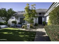 Beautiful single-story home with landscaped front yard and walkway at 10040 N 78Th Pl, Scottsdale, AZ 85258