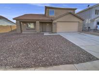 Two-story house with a brown exterior, a two-car garage, and a rock landscaping at 12517 W Rosewood Dr, El Mirage, AZ 85335