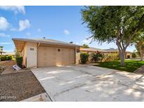 Front view of house with two car garage and lawn at 12613 W Brandywine Dr, Sun City West, AZ 85375