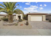 House exterior showcasing desert landscaping and a paved driveway at 14982 W Gentle Breeze Way, Surprise, AZ 85374
