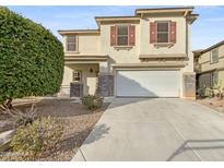 Two-story house with a two-car garage and landscaped front yard at 18164 W Smokey Dr, Surprise, AZ 85388