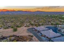 Aerial view of homes and desert landscape with mountain views at 18324 E Spring Valley Ct, Rio Verde, AZ 85263