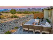 Covered patio with seating area, fire pit, and mountain views at 18324 E Spring Valley Ct, Rio Verde, AZ 85263