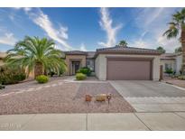 Single-story home with a two-car garage and desert landscaping at 19043 N Aztec Point Dr, Surprise, AZ 85387