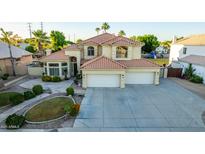 Two-story house with tile roof, three-car garage, and landscaped yard at 2042 E Victor Rd Rd, Gilbert, AZ 85296