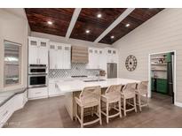 Modern kitchen with white cabinets, quartz countertops, and an island at 245 W Sagebrush St, Gilbert, AZ 85233