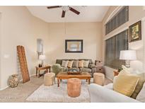 Spacious living room featuring a comfy sofa and large windows at 37110 W Leonessa Ave, Maricopa, AZ 85138