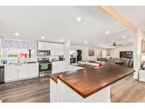Spacious kitchen featuring white cabinets, wood countertops, and modern appliances at 43459 N Terrace View Ave, San Tan Valley, AZ 85140