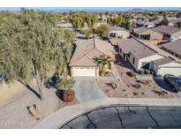Aerial view of single story house with desert landscaping, driveway, and neighborhood in background at 44932 W Gavilan Dr, Maricopa, AZ 85139