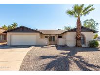 Single-story home with a two-car garage and desert landscaping at 5437 W Cholla St, Glendale, AZ 85304