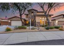 Two-story home with stone accents and landscaped front yard at 12259 W Lone Tree Trl, Peoria, AZ 85383