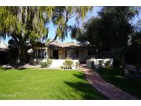 Charming single story home with a manicured lawn at 1526 W Wilshire Dr, Phoenix, AZ 85007