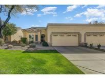 Beautiful desert landscape home with two-car garage and grassy yard at 19504 N 88Th Dr, Peoria, AZ 85382