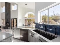 Modern kitchen features a large island, stainless steel appliances, and stylish cabinetry at 36039 N 58Th St, Cave Creek, AZ 85331