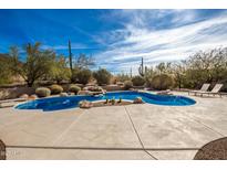 Inviting freeform pool with a large patio and mountain views at 36039 N 58Th St, Cave Creek, AZ 85331