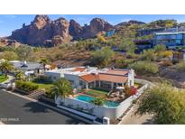 Aerial view showcasing home, pool, and mountain backdrop at 4601 E Solano Dr, Phoenix, AZ 85018