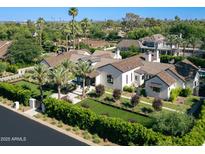 Stunning aerial view of a sprawling home with lush landscaping, pool, and palm trees in a desirable neighborhood at 6235 E Montecito Ave, Scottsdale, AZ 85251